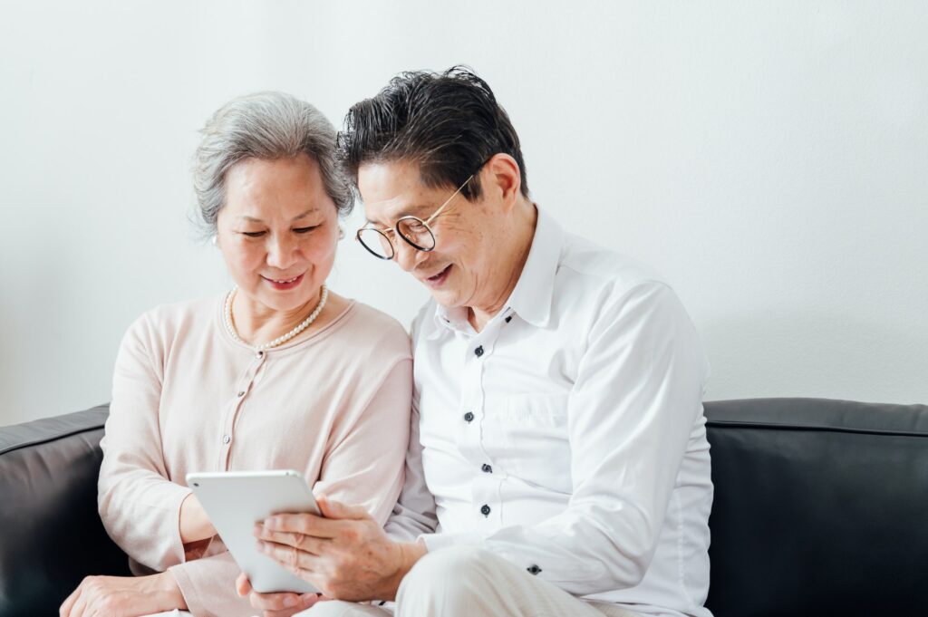 Senior Couple using ipad at home